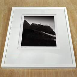 Photographie d'art et collection Denis Olivier, Dunnottar Castle, Stonehaven, Écosse. Août 2022. Ref-11617 - Denis Olivier Photographie, cadre blanc sur une table en bois