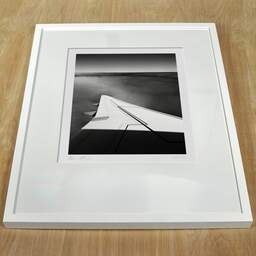 Art and collection photography Denis Olivier, Above, KL1278, North Sea, Netherlands. August 2022. Ref-11636 - Denis Olivier Photography, white frame on a wooden table