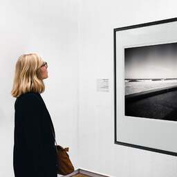 Art and collection photography Denis Olivier, Atlantic Coast, Ondres, France. March 2021. Ref-1417 - Denis Olivier Art Photography, A woman contemplate a large original photographic art print in limited edition and signed in a black frame