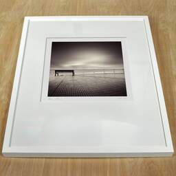 Art and collection photography Denis Olivier, Bench, Punta De La Dehesa, Spain. May 2007. Ref-1096 - Denis Olivier Photography, white frame on a wooden table