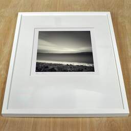 Art and collection photography Denis Olivier, Benderloch, First Of Lorn, Scotland. April 2006. Ref-981 - Denis Olivier Photography, white frame on a wooden table