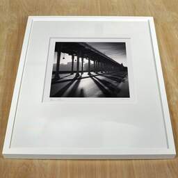 Art and collection photography Denis Olivier, Bir-Hakeim Bridge, Metro Line 6, Paris, France. February 2022. Ref-11527 - Denis Olivier Art Photography, white frame on a wooden table