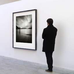 Art and collection photography Denis Olivier, Boat Ramp, Lake Maggiore, Italy. August 2014. Ref-11640 - Denis Olivier Art Photography, A visitor contemplate a large original photographic art print in limited edition and signed in a black frame