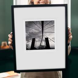Art and collection photography Denis Olivier, Bridge And Buildings, Bilbao, Spain. February 2022. Ref-11532 - Denis Olivier Art Photography, original 9 x 9 inches fine-art photograph print in limited edition and signed hold by a galerist woman