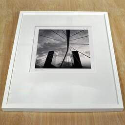 Art and collection photography Denis Olivier, Bridge And Buildings, Bilbao, Spain. February 2022. Ref-11532 - Denis Olivier Art Photography, white frame on a wooden table