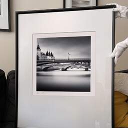 Art and collection photography Denis Olivier, Bridges Over The Seine River, Paris, France. February 2022. Ref-11585 - Denis Olivier Photography, large original 9 x 9 inches fine-art photograph print in limited edition and signed hold by a galerist woman
