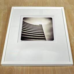 Art and collection photography Denis Olivier, Building Of Secrecy, Etude 3, L'Escala, Spain. September 2007. Ref-1114 - Denis Olivier Photography, white frame on a wooden table