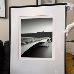 Art and collection photography Denis Olivier, Caroussel Bridge And Louvre, Paris, France. February 2021. Ref-11681 - Denis Olivier Art Photography, large original 9 x 9 inches fine-art photograph print in limited edition and signed hold by a galerist woman
