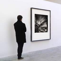 Art and collection photography Denis Olivier, Cement Factory, Etude 4, Quai Sainte-Croix, Bordeaux, France. September 2005. Ref-783 - Denis Olivier Art Photography, A visitor contemplate a large original photographic art print in limited edition and signed in a black frame