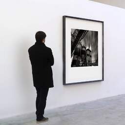 Art and collection photography Denis Olivier, Cement Factory, Etude 5, Quai Sainte-Croix, Bordeaux, France. September 2005. Ref-784 - Denis Olivier Art Photography, A visitor contemplate a large original photographic art print in limited edition and signed in a black frame