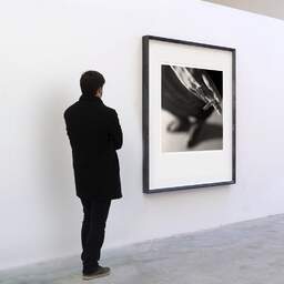 Art and collection photography Denis Olivier, Cigarette, Poitiers, France. April 1991. Ref-823 - Denis Olivier Art Photography, A visitor contemplate a large original photographic art print in limited edition and signed in a black frame