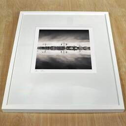 Art and collection photography Denis Olivier, Citizen Horizon, Water Mirror, Bordeaux, France. March 2008. Ref-1142 - Denis Olivier Photography, white frame on a wooden table