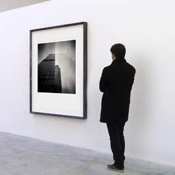 Art and collection photography Denis Olivier, City Buildings (double Exposure), London, UK. April 2014. Ref-1292 - Denis Olivier Art Photography, A visitor contemplate a large original photographic art print in limited edition and signed in a black frame