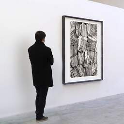 Art and collection photography Denis Olivier, Communauté D'Emmaüs, Poitiers, France. October 1990. Ref-96 - Denis Olivier Art Photography, A visitor contemplate a large original photographic art print in limited edition and signed in a black frame