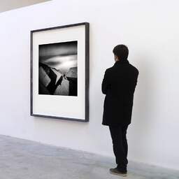Art and collection photography Denis Olivier, Concrete In Stormy Ocean, Bayonne, France. May 2007. Ref-1364 - Denis Olivier Art Photography, A visitor contemplate a large original photographic art print in limited edition and signed in a black frame