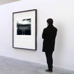 Art and collection photography Denis Olivier, Contemplation, Grand Hôtel De La Plage, Biscarrosse, France. May 2016. Ref-1314 - Denis Olivier Art Photography, A visitor contemplate a large original photographic art print in limited edition and signed in a black frame