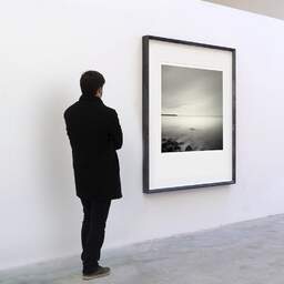 Art and collection photography Denis Olivier, Corniche Bay, Sète, France. August 2006. Ref-1035 - Denis Olivier Art Photography, A visitor contemplate a large original photographic art print in limited edition and signed in a black frame