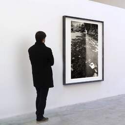 Art and collection photography Denis Olivier, Crossing, Landscape Park, Saint-Nazaire. July 2020. Ref-1350 - Denis Olivier Art Photography, A visitor contemplate a large original photographic art print in limited edition and signed in a black frame