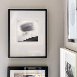 Art and collection photography Denis Olivier, Dark Cloud, Staffin Coast, Scotland. August 2022. Ref-11575 - Denis Olivier Photography, original fine-art photograph signed in limited edition in a black wooden frame with other images hung on the wall