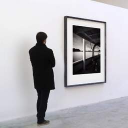 Art and collection photography Denis Olivier, Docks From The Belem, Bordeaux, France. June 2022. Ref-11624 - Denis Olivier Art Photography, A visitor contemplate a large original photographic art print in limited edition and signed in a black frame