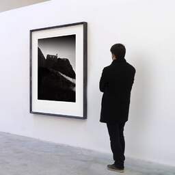 Art and collection photography Denis Olivier, Dunnottar Castle, Stonehaven, Scotland. August 2022. Ref-11617 - Denis Olivier Art Photography, A visitor contemplate a large original photographic art print in limited edition and signed in a black frame