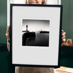 Art and collection photography Denis Olivier, East And West Jetty Lighthouses, Saint-Nazaire, France. August 2020. Ref-1425 - Denis Olivier Art Photography, original 9 x 9 inches fine-art photograph print in limited edition and signed hold by a galerist woman