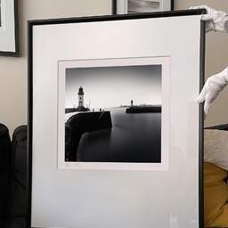 Art and collection photography Denis Olivier, East And West Jetty Lighthouses, Saint-Nazaire, France. August 2020. Ref-1425 - Denis Olivier Art Photography, large original 9 x 9 inches fine-art photograph print in limited edition and signed hold by a galerist woman