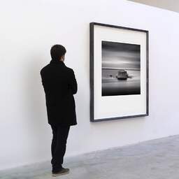 Art and collection photography Denis Olivier, East Dyke, Cherbourg-en-Cotentin, France. February 2012. Ref-11571 - Denis Olivier Art Photography, A visitor contemplate a large original photographic art print in limited edition and signed in a black frame