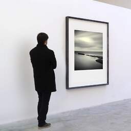 Art and collection photography Denis Olivier, East Helmsdale Harbour, Scotland, Scotland. April 2006. Ref-957 - Denis Olivier Art Photography, A visitor contemplate a large original photographic art print in limited edition and signed in a black frame