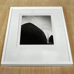 Art and collection photography Denis Olivier, Eiffel Tower, Invalides Garden, Paris, France. February 2023. Ref-11676 - Denis Olivier Art Photography, white frame on a wooden table