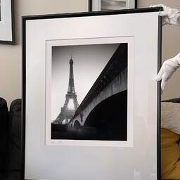 Art and collection photography Denis Olivier, Eiffel Tower Sunrise, Paris, France. February 2022. Ref-11625 - Denis Olivier Art Photography, large original 9 x 9 inches fine-art photograph print in limited edition and signed hold by a galerist woman