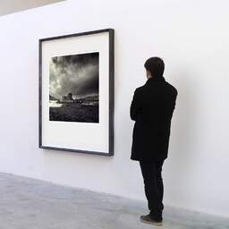 Art and collection photography Denis Olivier, Eilean Donan Castle, Etude 1, Highlands, Scotland. April 2006. Ref-953 - Denis Olivier Art Photography, A visitor contemplate a large original photographic art print in limited edition and signed in a black frame