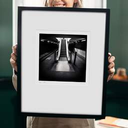 Art and collection photography Denis Olivier, Escalator, Saint-Jean Train Station, France. April 2021. Ref-11505 - Denis Olivier Photography, original 9 x 9 inches fine-art photograph print in limited edition and signed hold by a galerist woman