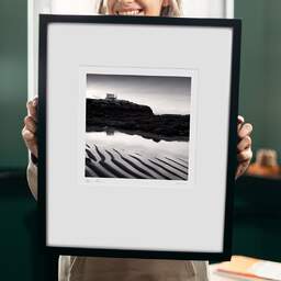 Art and collection photography Denis Olivier, Fishing Hut, Platin Beach, Saint-Palais-Sur-Mer, France. September 2022. Ref-11586 - Denis Olivier Art Photography, original 9 x 9 inches fine-art photograph print in limited edition and signed hold by a galerist woman