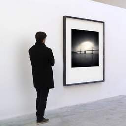 Art and collection photography Denis Olivier, Foggy Bay Bridge, San Francisco, United-States. February 2010. Ref-1236 - Denis Olivier Art Photography, A visitor contemplate a large original photographic art print in limited edition and signed in a black frame