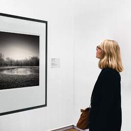 Art and collection photography Denis Olivier, Frozen Pond, Coperit, France. December 2005. Ref-894 - Denis Olivier Art Photography, A woman contemplate a large original photographic art print in limited edition and signed in a black frame