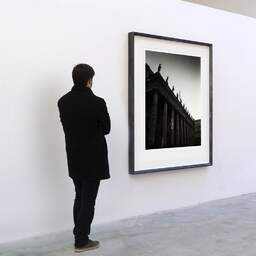 Art and collection photography Denis Olivier, Grand Theatre, Etude 3, Bordeaux, France. December 2022. Ref-11641 - Denis Olivier Art Photography, A visitor contemplate a large original photographic art print in limited edition and signed in a black frame