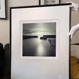 Art and collection photography Denis Olivier, Harbour Broch, Scotland, Scotland. April 2006. Ref-965 - Denis Olivier Art Photography, large original 9 x 9 inches fine-art photograph print in limited edition and signed hold by a galerist woman