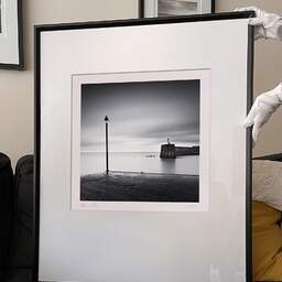 Art and collection photography Denis Olivier, Harbour Entrance, Bourcefranc-Le-Chapus, France. November 2021. Ref-11554 - Denis Olivier Photography, large original 9 x 9 inches fine-art photograph print in limited edition and signed hold by a galerist woman