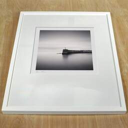 Art and collection photography Denis Olivier, Harbour Pier, Bourcefrance-Le-Chapus, France. November 2021. Ref-11566 - Denis Olivier Photography, white frame on a wooden table