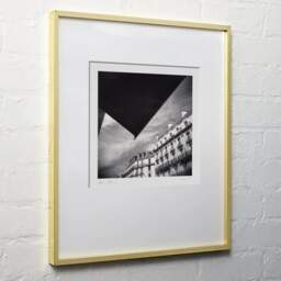 Art and collection photography Denis Olivier, Haussmann Buildings, Auber Street, Paris, France. August 2021. Ref-11480 - Denis Olivier Photography, light wood frame on white wall