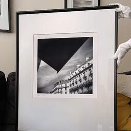 Art and collection photography Denis Olivier, Haussmann Buildings, Auber Street, Paris, France. August 2021. Ref-11480 - Denis Olivier Photography, large original 9 x 9 inches fine-art photograph print in limited edition and signed hold by a galerist woman