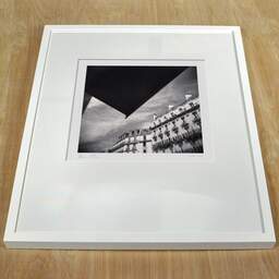 Art and collection photography Denis Olivier, Haussmann Buildings, Auber Street, Paris, France. August 2021. Ref-11480 - Denis Olivier Photography, white frame on a wooden table