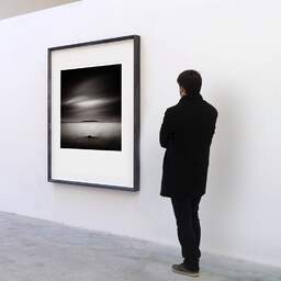 Art and collection photography Denis Olivier, Hersnap, Denmark. October 2008. Ref-1211 - Denis Olivier Art Photography, A visitor contemplate a large original photographic art print in limited edition and signed in a black frame