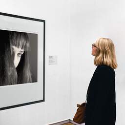 Art and collection photography Denis Olivier, Hidden Eye, Poitiers, France. April 1991. Ref-824 - Denis Olivier Art Photography, A woman contemplate a large original photographic art print in limited edition and signed in a black frame