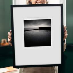 Art and collection photography Denis Olivier, Horizon And Pier Edge, Les Boucholeurs, France. December 2010. Ref-1258 - Denis Olivier Art Photography, original 9 x 9 inches fine-art photograph print in limited edition and signed hold by a galerist woman