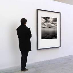 Art and collection photography Denis Olivier, L'ile Aux Moines, Arradon, France. August 2005. Ref-761 - Denis Olivier Art Photography, A visitor contemplate a large original photographic art print in limited edition and signed in a black frame