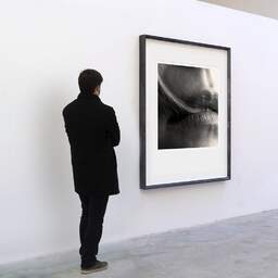 Art and collection photography Denis Olivier, In The Hairs Today, Bordeaux, France. April 2005. Ref-576 - Denis Olivier Art Photography, A visitor contemplate a large original photographic art print in limited edition and signed in a black frame