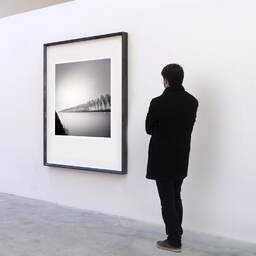 Art and collection photography Denis Olivier, Kanaaldijk Oost, Utrecht, Netherlands. April 2015. Ref-11563 - Denis Olivier Art Photography, A visitor contemplate a large original photographic art print in limited edition and signed in a black frame
