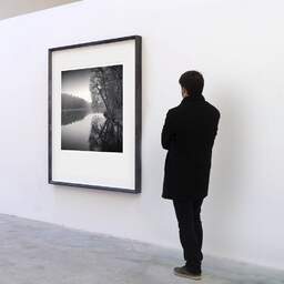 Art and collection photography Denis Olivier, La Claie, Kerguehennec Castle Park, France. January 2008. Ref-11543 - Denis Olivier Art Photography, A visitor contemplate a large original photographic art print in limited edition and signed in a black frame